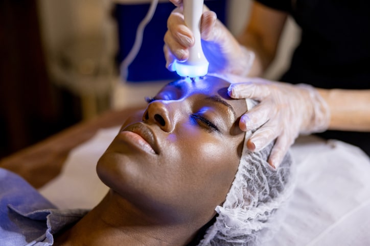 Black Woman Getting Light Skin Therapy