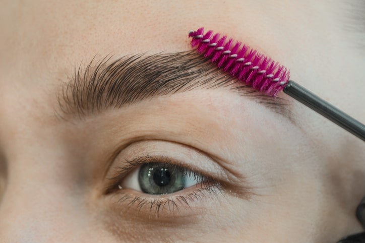 Woman Brushing Her Laminated Eyebrows