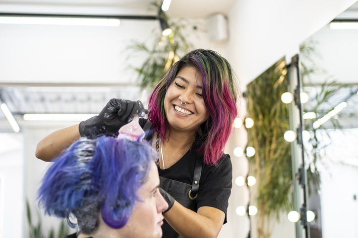 Coloring a woman's hair in a beauty salon
