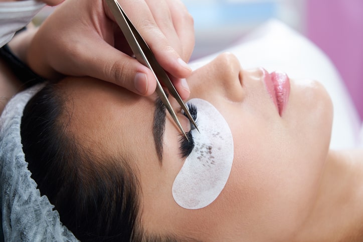 Esthetician applying Eyelash Extensions