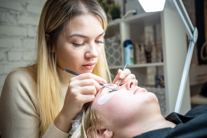 Esthetician applying eyelash extensions