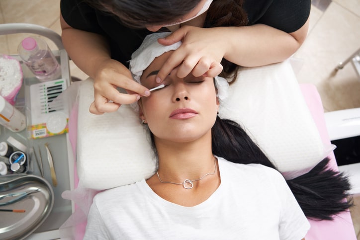 Woman Applying Eyelash Extensions