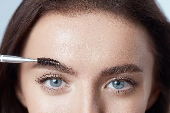 Woman Brushing Her Eyebrows