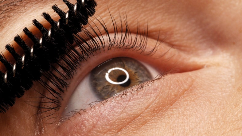 Woman Brushing Lashes with Lash Lift