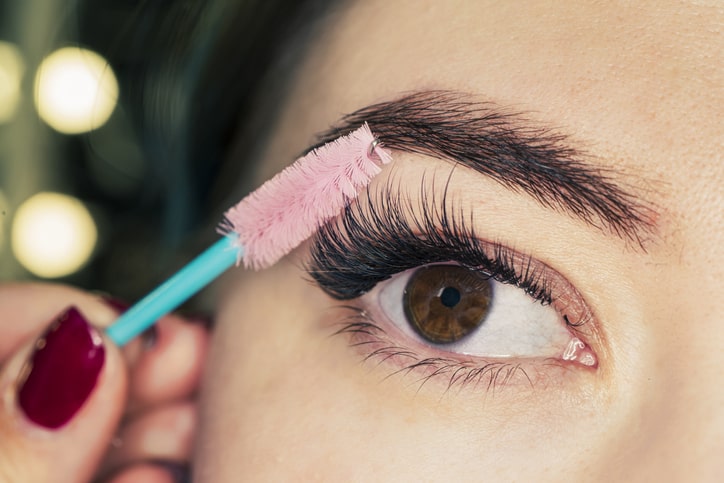 Woman Brushing Her Eyelashes