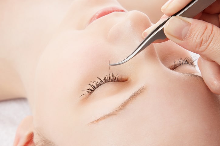 Woman Getting Eyelash Extensions Applied