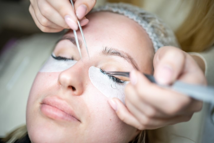 Woman Getting Eyelash Extensions Applied