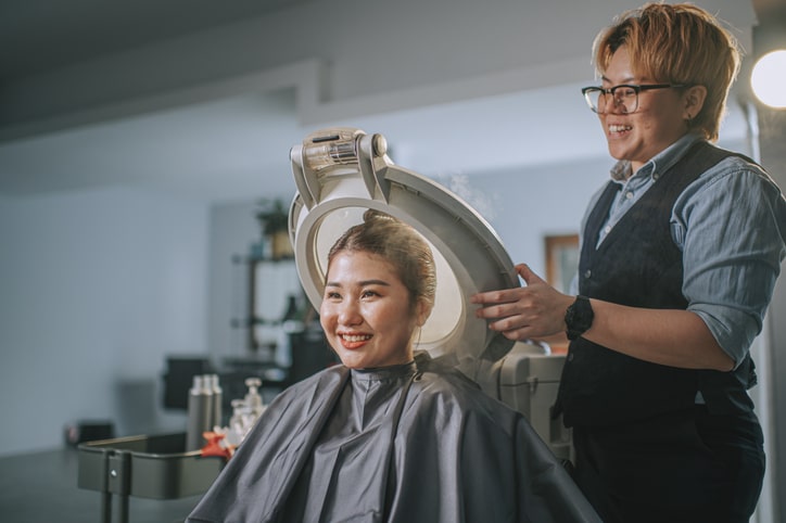 Woman Getting hair treatment at salon