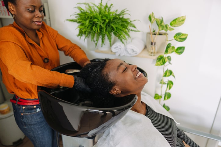 Woman Getting Hair Washed at Beauty Salon