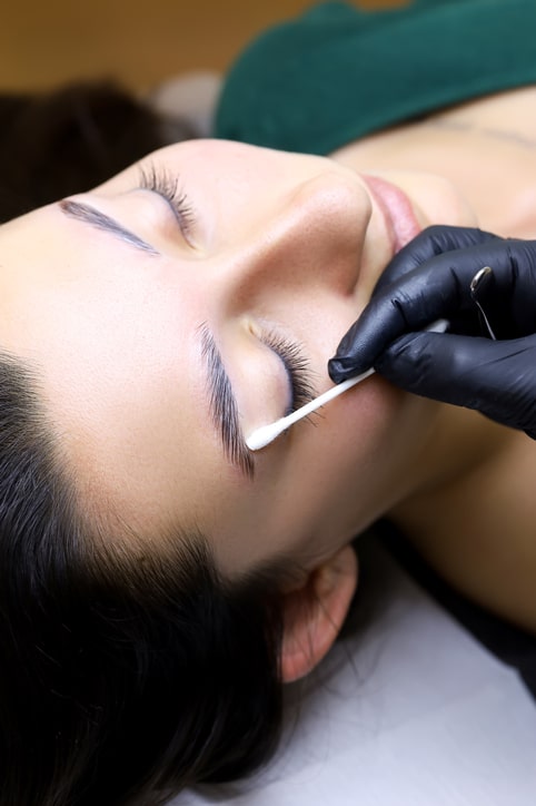 Woman laying down getting eyebrows laminated
