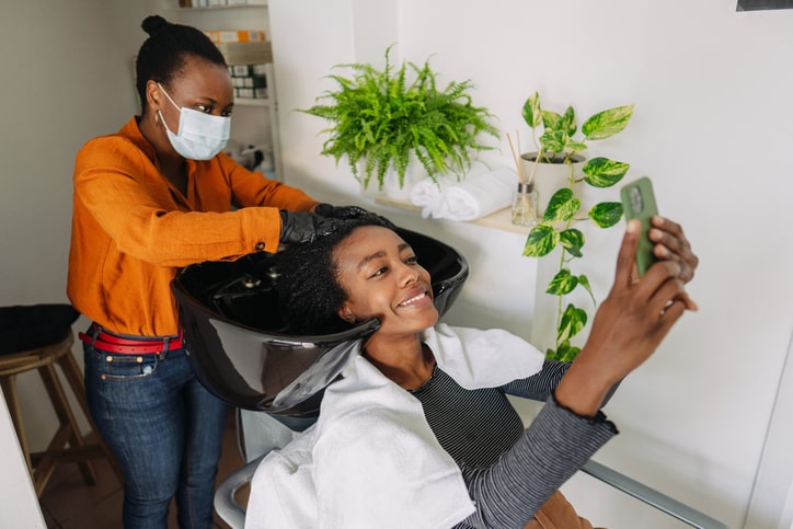 Woman washing hair in beauty salon