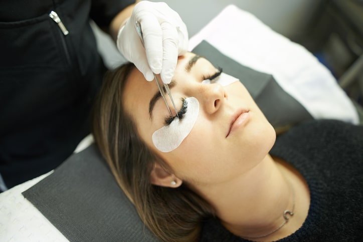 Woman with eyelash extension supplies